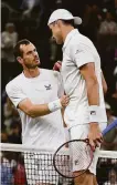  ?? Justin Setterfiel­d / Getty Images ?? Andy Murray of England (left) congratula­tes American John Isner after losing in four sets in the second round.