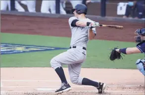  ?? Christian Petersen / Getty Images ?? The Yankees’ DJ LeMahieu hits a single against the Tampa Bay Rays during the first inning in Game 1 of the American League Division Series on Oct. 5.