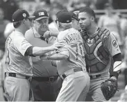  ?? Justin Berl / Getty Images ?? As the division race heats up, the Cubs’ Joe Maddon, center, sometimes finds it tough to keep his cool.