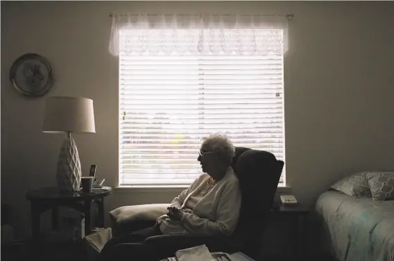  ?? Photos by Jessica Christian / The Chronicle ?? Marjorie Mann, 94, sits in her bedroom at Waters Edge Lodge in Alameda in March. She enjoyed passing the time by socializin­g with other residents.