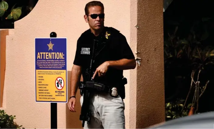  ?? Photograph: Joe Cavaretta/AP ?? A Secret Service agent stands outside of Mar-a-Lago in Florida.