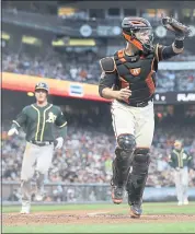  ?? MARCIO JOSE SANCHEZ — THE ASSOCIATED PRESS ?? The A’s Matt Chapman, left, scores as Giants catcher Buster Posey chase down a wide throw to home plate Saturday.
