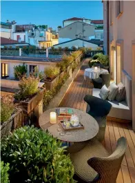  ??  ?? The Mandarin Terrace Suite has a long balcony that looks down onto the courtyard and across the tiled rooftops of downtown Milan