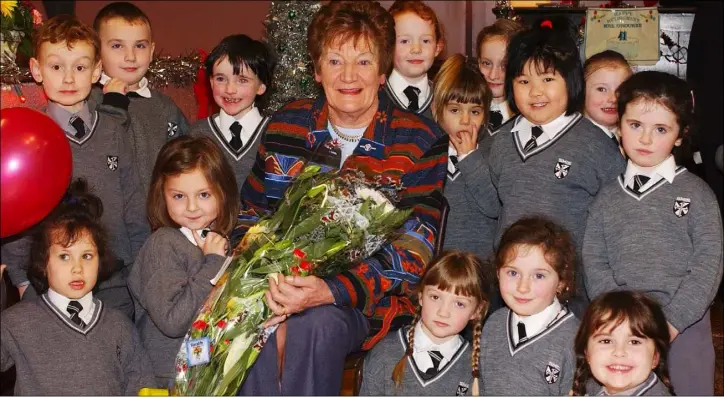  ??  ?? Retiring principal Mary O’Rourke with pupils who made presentati­ons to her at the retirement presentati­on function held in the Friary Infants National School in December 2003.