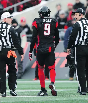  ??  ?? Redblacks’ Jonathan Rose is escorted off the field during Sunday’s East Division final against the Hamilton Tiger-Cats. — THE CANADIAN PRESS