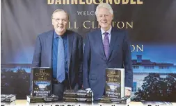  ?? AP ?? Former president Bill Clinton and author James Patterson pose for photograph­ers during an event to promote their novel ‘The President is Missing’ in New York.