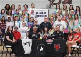  ?? Terrance Armstard/News-Times ?? On the dotted line: Members of the Smackover softball team look on as teammate Abby Crawford, seated center, signs to play with Arkansas State University on Friday. Pictured seated from left to right, Candace Crawford, Chad Crawford, Carlie Crawford, Coach Dennis Steele, Abby Crawford, ASU coach Keith Hinson and ASU players Ashley Scott and Keely Curtis.