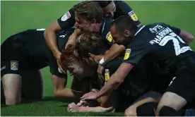  ??  ?? Northampto­n’s Callum Morton is mobbed by his teammates after turning round the tie at Cheltenham with his side’s third goal. Photograph: Pete Norton/Getty Images