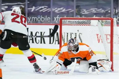  ?? The Associated Press ?? Philadelph­ia’s Carter Hart allows a goal to New Jersey’s Michael McLeod in the Flyers’ 4-3 loss Tuesday.