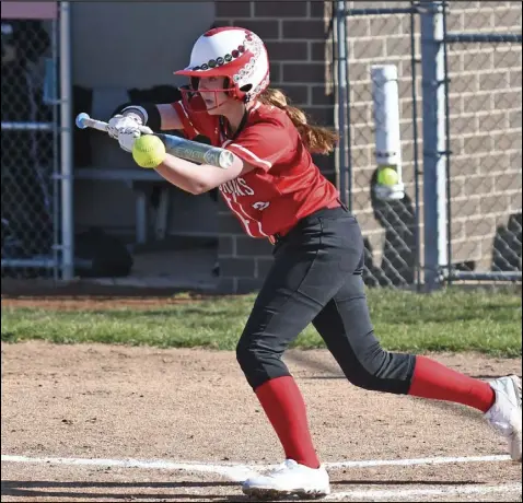  ?? Photo by John Zwez ?? Allie Wilson of Wapakoneta bunts the ball during Monday’s game against Spencervil­le. The Lady Redskins won the game in five innings. See more photos at wapakdaily­news.com.