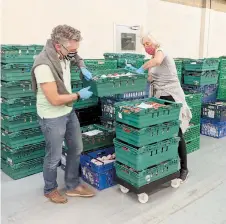  ??  ?? Some 60 volunteers helped move the produce.