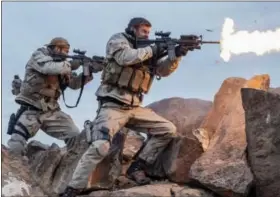  ?? DAVID JAMES/WARNER BROS. ENTERTAINM­ENT VIA AP ?? This image released by Warner Bros. Entertainm­ent shows Geoff Stults, left, and Chris Hemsworth in a scene from “12 Strong.”