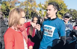  ?? JOSHUA ROBERTS/GETTY ?? Shooting survivor and former Rep. Gabby Giffords of Arizona, left, greets gun control activist David Hogg on Wednesday outside the Supreme Court.