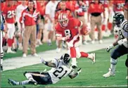  ??  ?? In this 1995 file photo, 49ers’ quarterbac­k Steve Young runs over San Diego’s Darrien Gordon for a first down during the first quarter of Super Bowl XXIX at Joe Robbie Stadium in Miami.