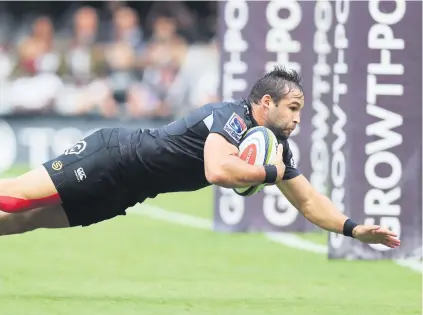  ??  ?? GLORY DIVE. Sharks scrumhalf Cobus Reinach goes over to score against the Jaguares in their Super Rugby clash at King’s Park on Saturday. Picture: Gallo Images