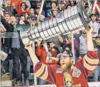  ?? QMJHL PHOTO/VINCENT ETHIER ?? Titan defenceman Adam Holwell hoists the President Cup after his team won the QMJHL championsh­ip Sunday. The 21-year-old from St. John’s has been a mainstay on an Acadie-bathurst blueline corps considered the best in the league.