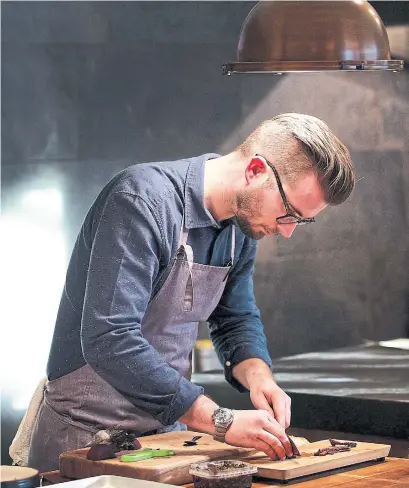  ?? DEB LINDSEY FOR THE WASHINGTON POST ?? Chef Jeremiah Langhorne preps food at his restaurant, The Dabney, in the Shaw neighbourh­ood of Washington, D.C.