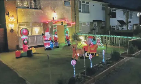  ??  ?? BRIGHT HOPES Mark Duncan from Waterloovi­lle and his 16-year-old son Will, below, are hoping their light display will encourage people to dig deep Macmillan Cancer Support