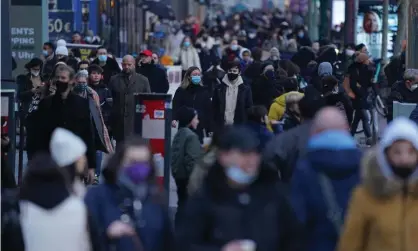  ?? Photograph: Sean Gallup/Getty Images ?? Shoppers in Berlin’s Tauentzien­strasse before Christmas. Non-essential retail stayed open in Germany for most of last year.