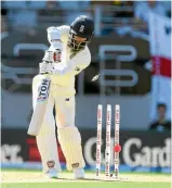  ?? PHOTOS: PHOTOSPORT/GETTY IMAGES ?? England wickets tumbled regularly in the opening session. Left, Chris Woakes has his stumps shattered by Trent Boult; right, Moeen Ali suffers a similar fate from Tim Southee.