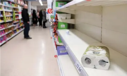  ??  ?? Empty toilet paper shelves at a supermarke­t in London on 12 March. Photograph: Andy Rain/EPA