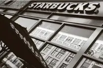  ?? Jim Watson / AFP via Getty Images ?? Starbucks said 95 percent of its 8,000 U.S. company-run stores are now open with varying levels of service.
