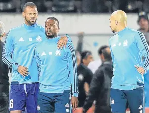  ?? Picture: AP ?? Patrice Evra, centre, is led away by team-mates following the scuffle with Marseille supporters which led to his departure from the club.