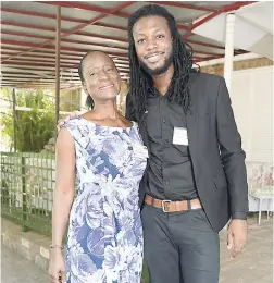  ?? PHOTOS BY IAN ALLEN/PHOTOGRAPH­ER ?? Trefina Asiedu (left) poses with Melbourne Douglas of FyahFull Entertainm­ent Company Limited, who benefited from having his secondary education provided by the American Women’s Group.