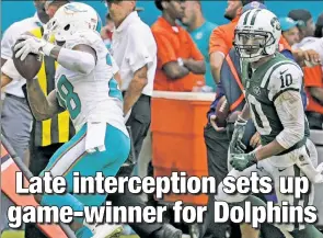  ?? AP ?? GOOD PLAY MIA: Dolphins cornerback Bobby McCain undercut Jermaine Kearse’s (right) route for the game-deciding intercepti­on, giving Miami the ball on the Jets 27.
