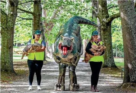  ?? DAVID UNWIN/STUFF ?? People going to Dinofest will get the chance to meet friendly Rexy and dinosaur rangers Danielle Witute, left, and Monique Bradley.