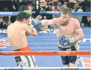  ??  ?? Canelo Alvarez (right) goes on the offensive against Julio Cesar Chavez, Jr. at the T-Mobile Arena in Las Vegas, Nevada. — AFP photo