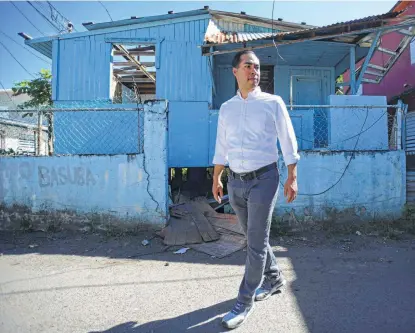  ?? Photos by Carlos Giusti / Associated Press ?? Presidenti­al candidate Julián Castro toured the Puerto Rican neighborho­od of La Playita, one of the communitie­s most affected by Hurricane Maria. Castro said his background helps him understand the process of recovering from a natural disaster.