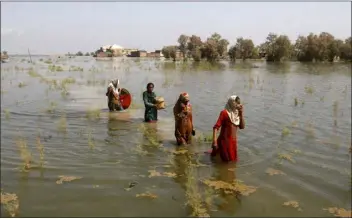  ?? FAREED KHAN — THE ASSOCIATED PRESS FILE ?? Pakistani women wade through floodwater­s as they take refuge in Shikarpur district of Sindh Province of Pakistan on Sept. 2, 2022. A major new United Nations report released Monday provided a sobering reminder that time is running out if humanity wants to avoid passing a dangerous global warming threshold.