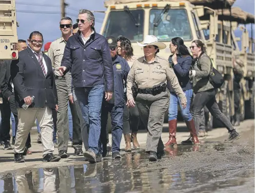  ?? SHMUEL THALER/THE SANTA CRUZ SENTINEL VIA AP ?? California Gov. Gavin Newsom tours flood damage in Pajaro, Calif., on Wednesday.