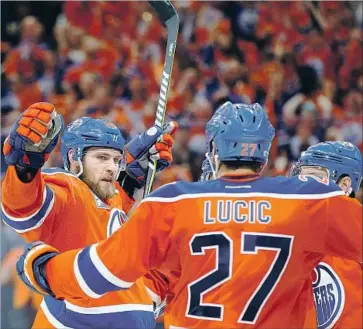  ?? Codie McLachlan Getty Images ?? LEON DRAISAITL, left, of the Oilers celebrates a hat-trick goal in Game 6 of the Western Conference second round. Draisaitl has 11 goals in 11 regular-season and playoff games against the Ducks this season.