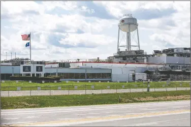  ?? (Iowa City Press-Citizen/Joseph Cress) ?? A Tyson Foods processing plant is seen during the coronaviru­s pandemic April 14 in Columbus Junction, Iowa. Tyson, Cargill and other major meat processing companies say they are adopting several measures — such as taking the temperatur­e of everyone entering plants, adding clear plastic shields between work stations and erecting tents — to allow workers to spread out more at lunch.