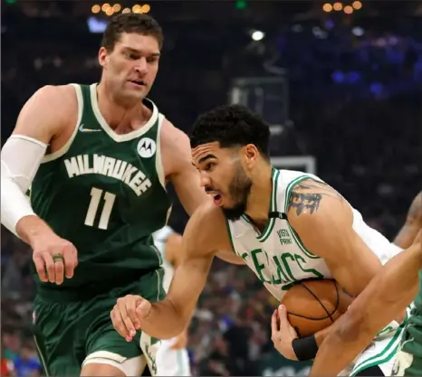 ?? Stacy Revere/Getty Images ?? Boston’s Jayson Tatum drives to the basket against Milwaukee’s Brook Lopez in the first quarter of Game 6 Friday night.