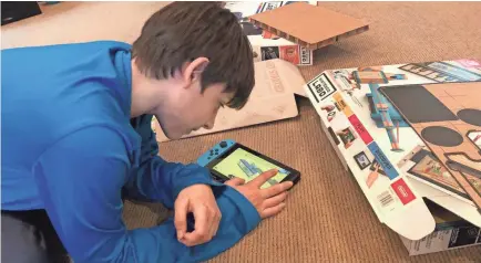  ?? USA TODAY ?? Sam Baig plays with Nintendo Labo, which marries Nintendo’s Switch system with a cardboard building set.