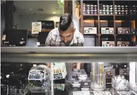  ?? Jae C. Hong / Associated Press 2017 ?? Jerred Kiloh, owner of the Higher Path medical marijuana dispensary, stocks shelves with cannabis products in Los Angeles.