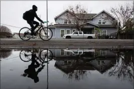  ?? PHOTO: DAI SUGANO — BAY AREA NEWS GROUP ?? A bicyclist is reflected in a rain puddle in San Jose on Thursday, Dec. 29, 2022. The Bay Area got an introducto­ry glimpse of the coming rains when residents woke up to wet and rainy conditions Thursday.