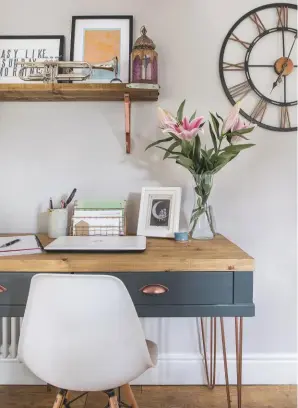  ??  ?? KITCHEN Leanne had the desk custom-made to her design and constructe­d the shelf above with a waxed scaffold board and copper brackets. Desk, £799, Parker Howley. Weathered wood cut-out clock is similar, £125, Cox & Cox