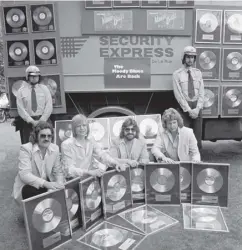 ??  ?? Ray Thomas, far left, with the rest of the Moody Blues and their collection of platinum discs presented by record company Decca