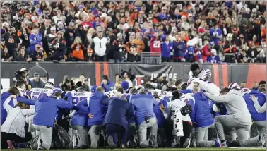  ?? JOSHUA A. BICKEL — THE ASSOCIATED PRESS ?? Buffalo Bills players and staff pray for Damar Hamlin after the Bills player collapsed and went into cardiac arrest during an NFL game against the Cincinnati Bengals on Jan. 2.