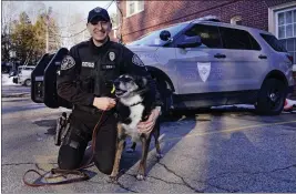  ?? PHOTOS BY CHARLES KRUPA — THE ASSOCIATED PRESS ?? Rhode Island State Police Cpl. Daniel O'Neill poses with his partner, Ruby, a working state police K-9and former shelter dog, outside the state police barracks in North Kingstown, R.I., Wednesday. The Australian shepherd and border collie mix will be featured in a Netflix movie titled “Rescued by Ruby.”