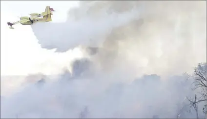  ?? Signal file
photo ?? A Super Scooper works to extinguish the Rye Fire in Santa Clarita in December. The House of Representa­tives is allowing victims to deduct value of losses from their taxes. Congressma­n Steve Knight co-sponsored the bill.