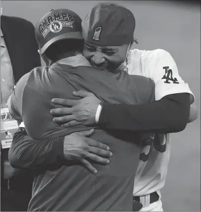  ?? TOM PENNINGTON/GETTY ?? Mookie Betts hugs Dodgers President Andrew Friedman after winning the franchise’s seventhWor­ld Series on Tuesday night.