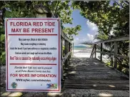  ?? RICHARD GRAULICH / THE PALM BEACH POST ?? Newly printed signs along State Road A1A in Jupiter, Fla., on Thursday warn visitors of the red tide outbreak.