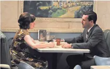  ?? AMC ?? Peggy Olson (Elisabeth Moss) and Don Draper (Jon Hamm) have an intimate dinner in Season 4.