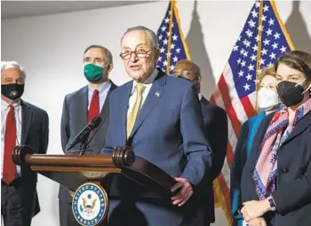  ?? AMANDA ANDRADE-RHOADES AP ?? Senate Majority Leader Chuck Schumer, D-N.Y., is joined by other Democratic senators Tuesday during a news conference about voting rights legislatio­n. Initial voting could start as soon as today.