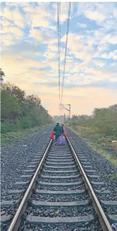  ?? RP-FOTOS: JAN SCHÜRMANN ?? Ihre gepackten Sachen schleppen diese beiden Rumänen wie so viele andere an diesem Morgen über die Gleise.